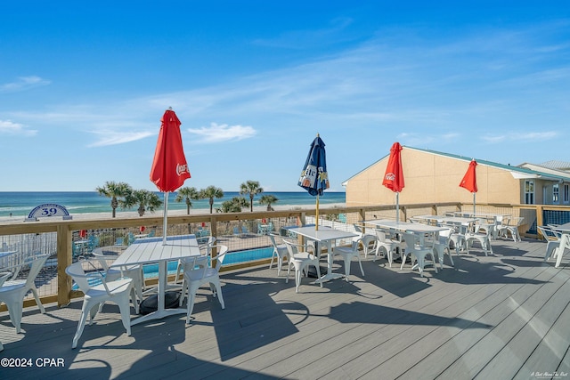 deck with a water view and a beach view