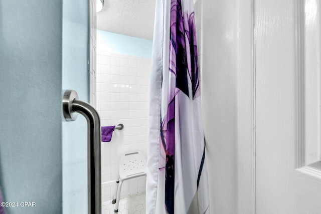 23223 Front Beach Rd Unit 713, Panama City Beach, FL 32413 - bathroom with a shower with shower curtain, a textured ceiling, and tile patterned floors