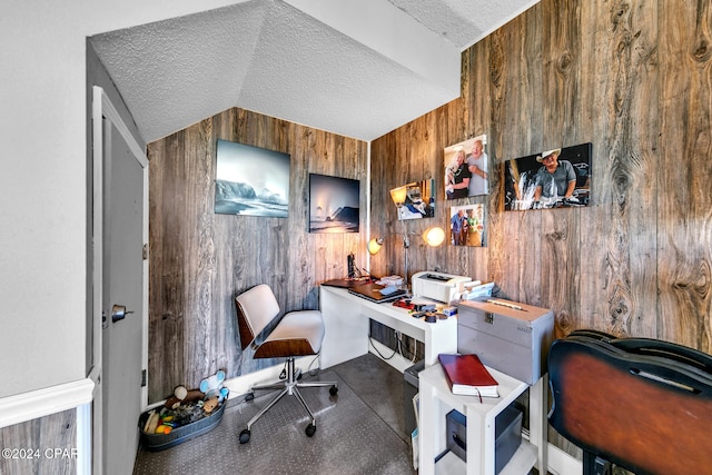 office area featuring wood walls and a textured ceiling