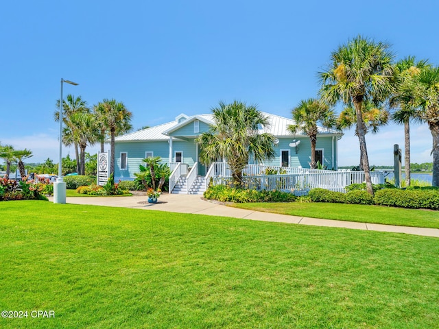 view of front of house featuring a porch, a front yard, and fence