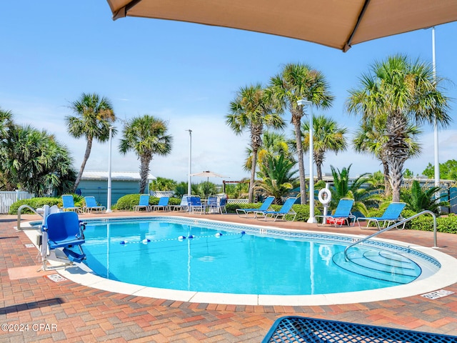 pool featuring a patio and fence