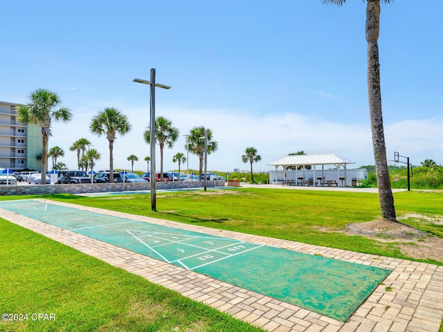 view of community featuring a gazebo, a yard, and shuffleboard