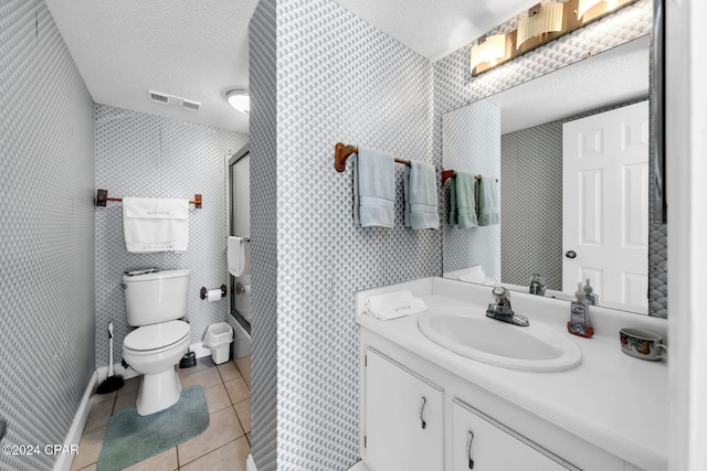 bathroom featuring a shower with shower door, visible vents, toilet, a textured ceiling, and tile patterned flooring