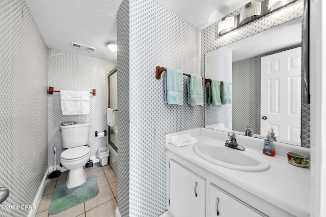 full bath featuring tile patterned floors, toilet, visible vents, and a textured ceiling