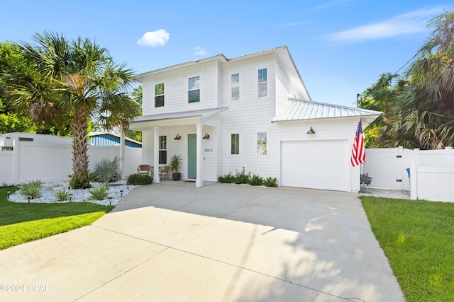 view of front of home with a front lawn and a garage