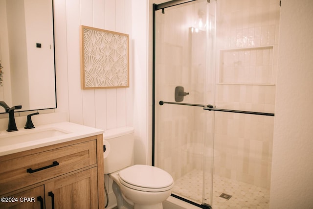 bathroom featuring vanity, toilet, and an enclosed shower