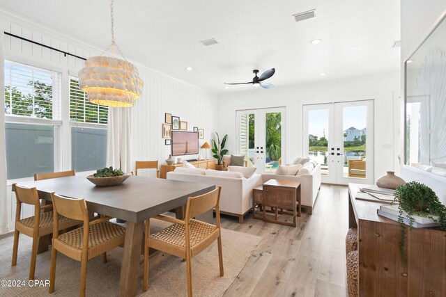 living room with ceiling fan and crown molding