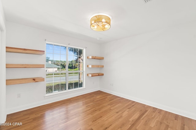 unfurnished room featuring hardwood / wood-style flooring