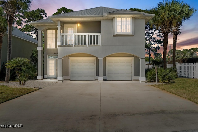 view of front facade featuring a balcony and a garage