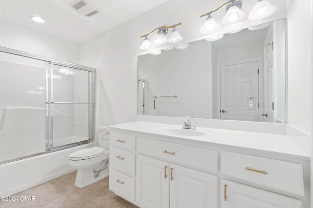 full bathroom featuring tile patterned floors, shower / bath combination with glass door, vanity, and toilet