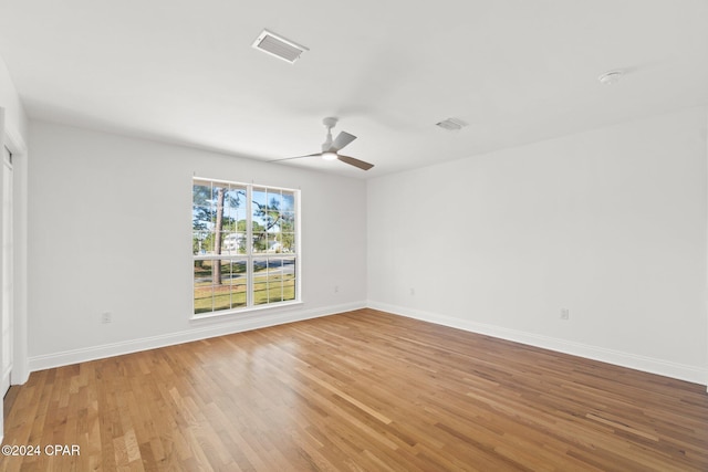 spare room featuring wood-type flooring and ceiling fan