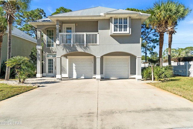 view of front of home with a garage and a balcony