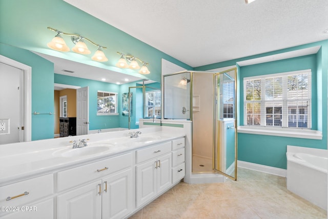 bathroom with tile patterned floors, vanity, a textured ceiling, and independent shower and bath