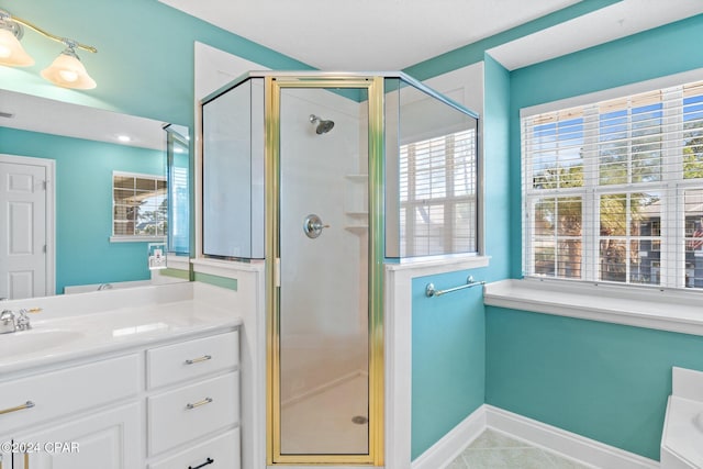 bathroom with tile patterned flooring, vanity, and an enclosed shower