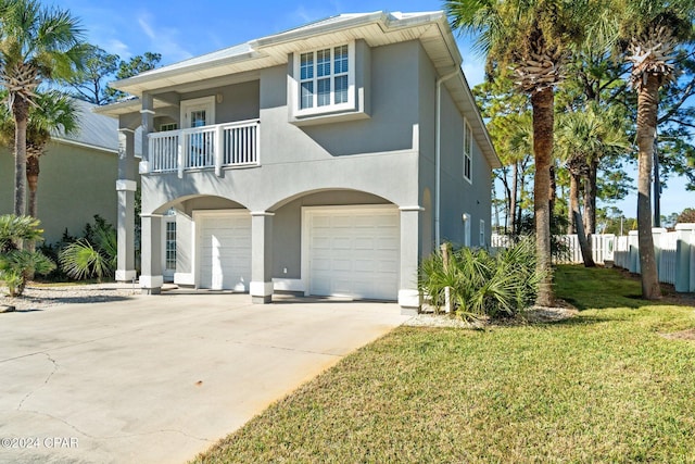 view of front of property featuring a front yard, a balcony, and a garage