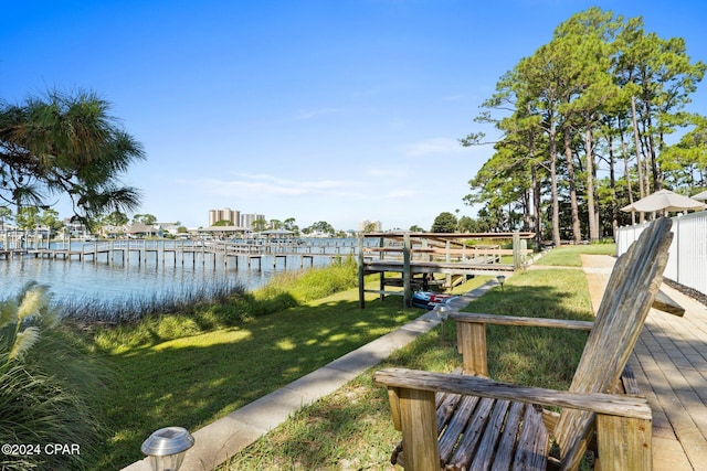 dock area featuring a water view and a lawn