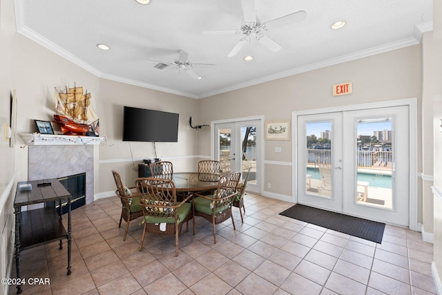 dining space with french doors, crown molding, and a healthy amount of sunlight