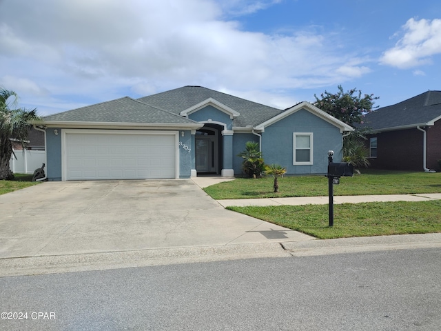 single story home featuring a front yard and a garage