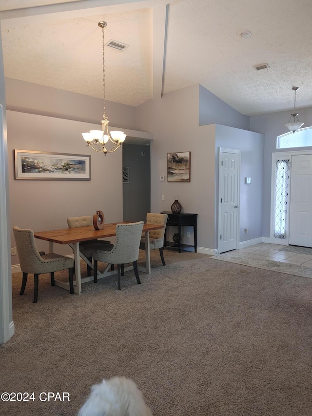 carpeted dining room with a textured ceiling and an inviting chandelier