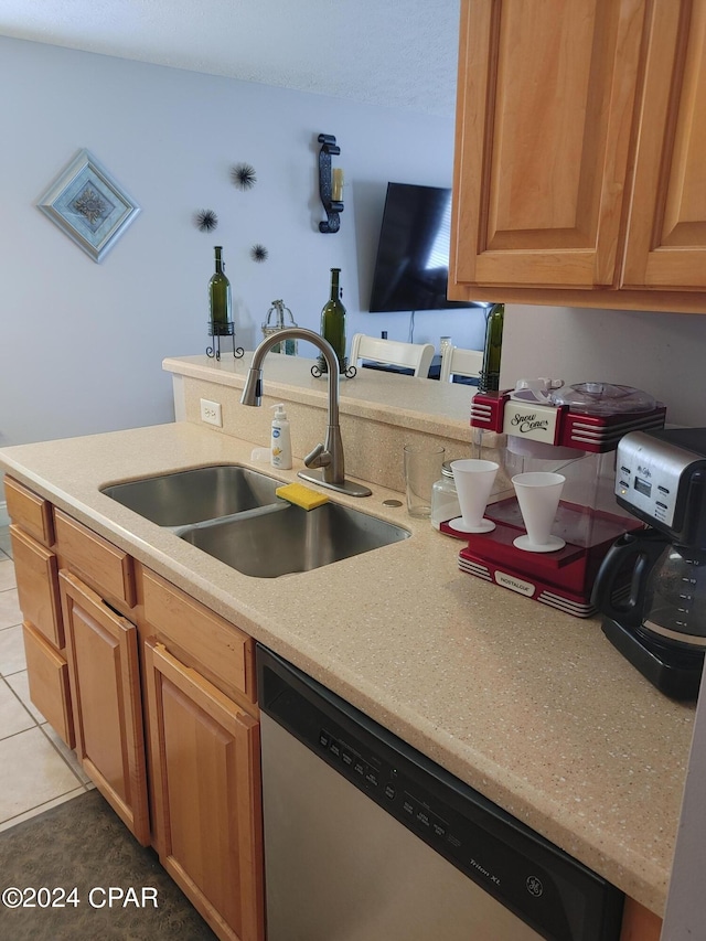 kitchen featuring dishwasher, light tile patterned flooring, and sink