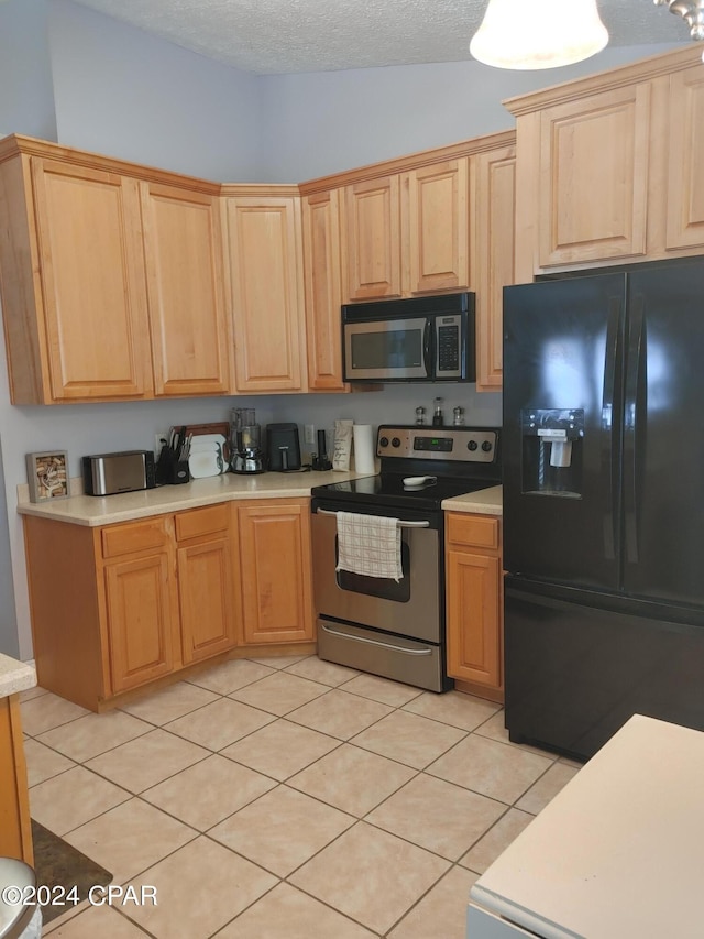 kitchen featuring a textured ceiling, light tile patterned flooring, stainless steel appliances, and lofted ceiling