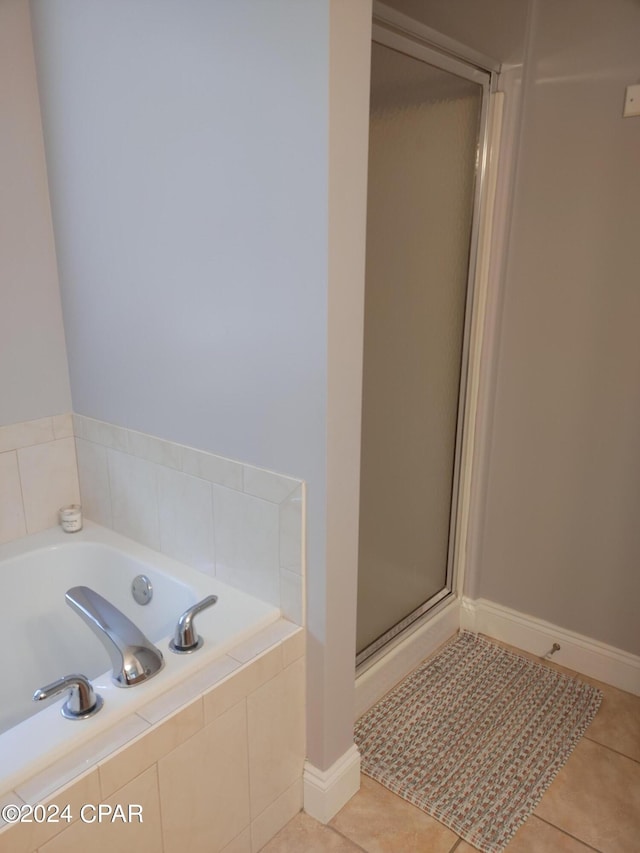 bathroom with tile patterned floors and plus walk in shower