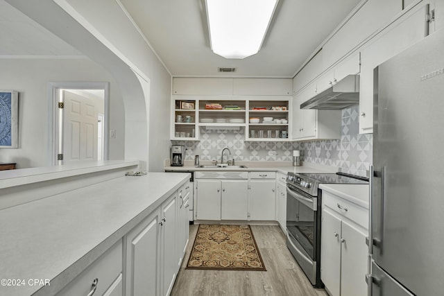 kitchen with backsplash, stainless steel appliances, sink, light hardwood / wood-style flooring, and white cabinets