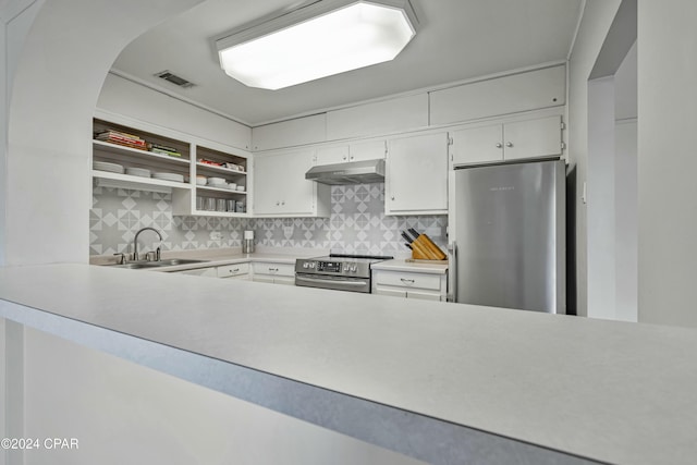 kitchen featuring appliances with stainless steel finishes, backsplash, white cabinetry, and sink