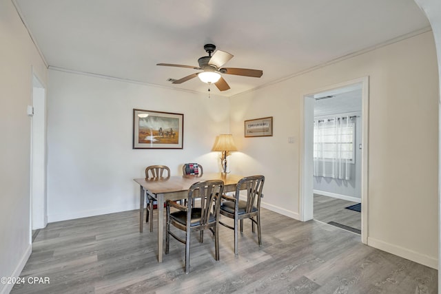 dining space featuring crown molding, hardwood / wood-style floors, and ceiling fan