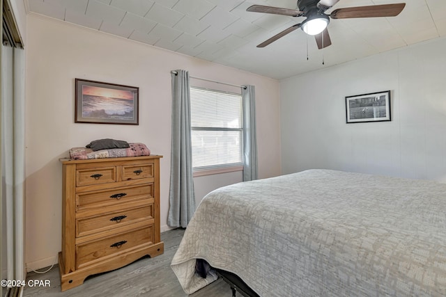 bedroom featuring ceiling fan, light hardwood / wood-style floors, and ornamental molding