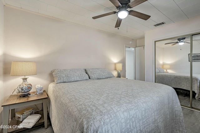 bedroom featuring a closet, ceiling fan, and ornamental molding