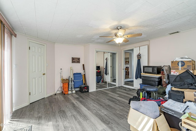 interior space featuring hardwood / wood-style floors, ceiling fan, and ornamental molding