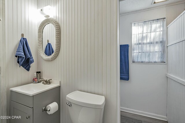 2406 Sewanee St, Lynn Haven, FL 32444 - bathroom with vanity, toilet, and wood finished floors