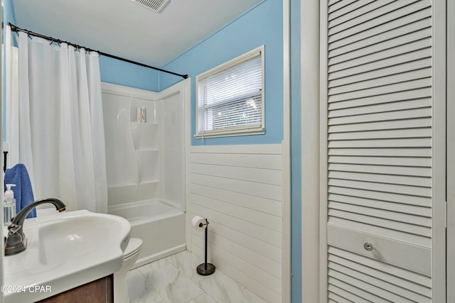 full bathroom with vanity, shower / bath combo, and toilet