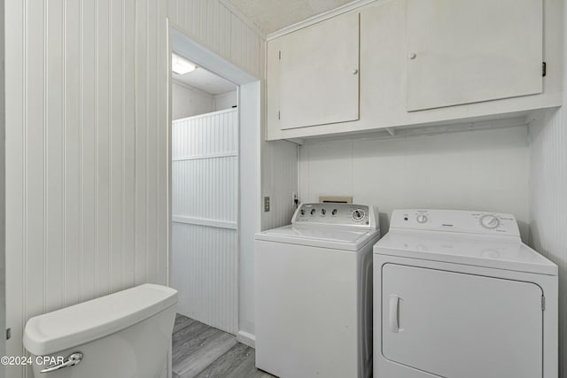 washroom featuring washing machine and clothes dryer, laundry area, and light wood finished floors