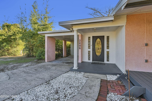 2406 Sewanee St, Lynn Haven, FL 32444 - entrance to property with concrete driveway, stucco siding, and a carport