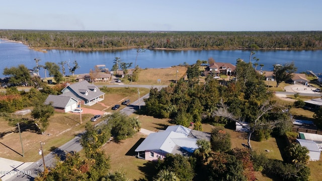 drone / aerial view with a water view, a view of trees, and a residential view