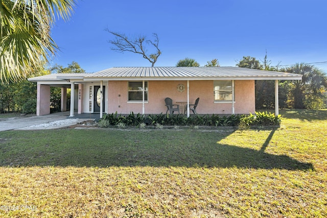 view of front of property with a front yard and a carport