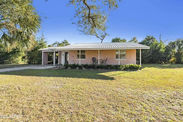 single story home with a front lawn and a carport