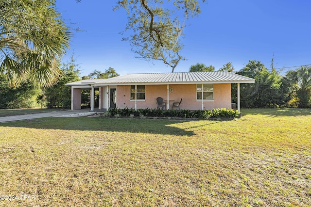 2406 Sewanee St, Lynn Haven, FL 32444 - ranch-style house featuring concrete driveway, stucco siding, metal roof, and a front yard