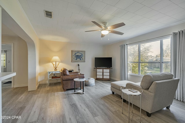 living room featuring light hardwood / wood-style floors, a wealth of natural light, and ceiling fan