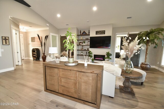 living room featuring light hardwood / wood-style floors and lofted ceiling