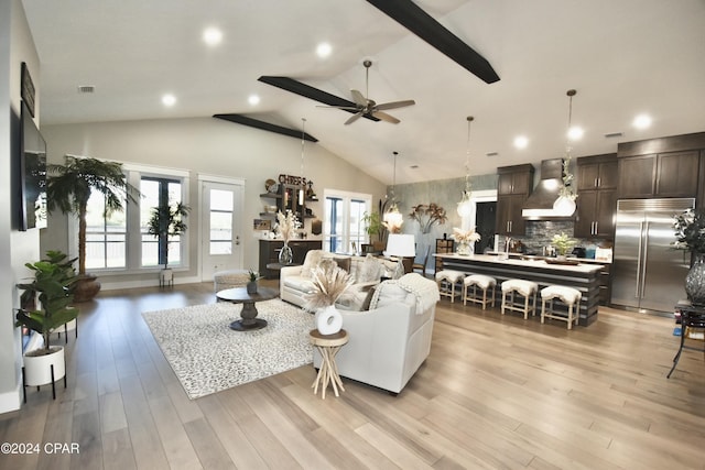 living room with a wealth of natural light, light hardwood / wood-style floors, and ceiling fan