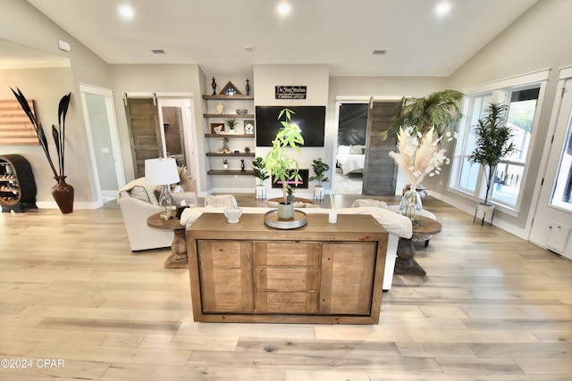 living room featuring light hardwood / wood-style floors and lofted ceiling