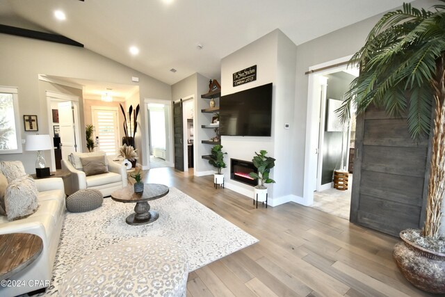 living room featuring vaulted ceiling and hardwood / wood-style flooring