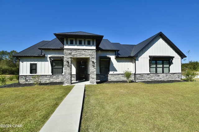 modern inspired farmhouse with a front lawn