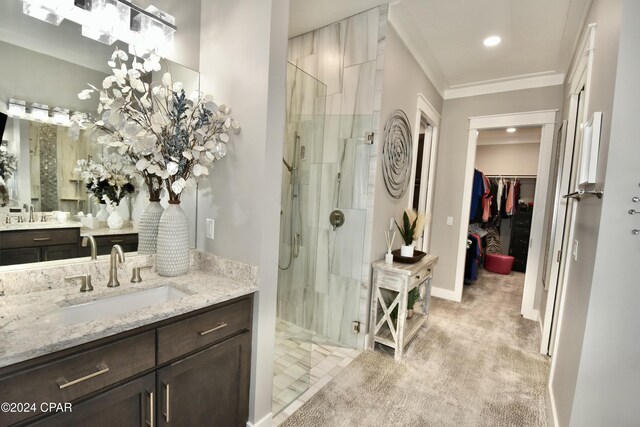 bathroom featuring vanity, a tile shower, and crown molding