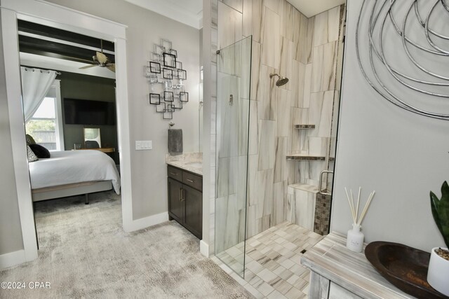 bathroom featuring ceiling fan, a shower with door, and vanity