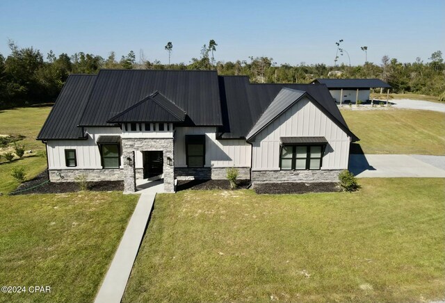 modern farmhouse style home with a front lawn