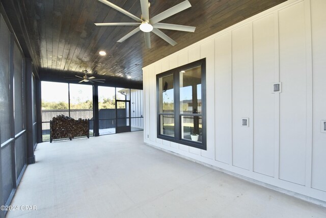 sunroom with ceiling fan and wooden ceiling